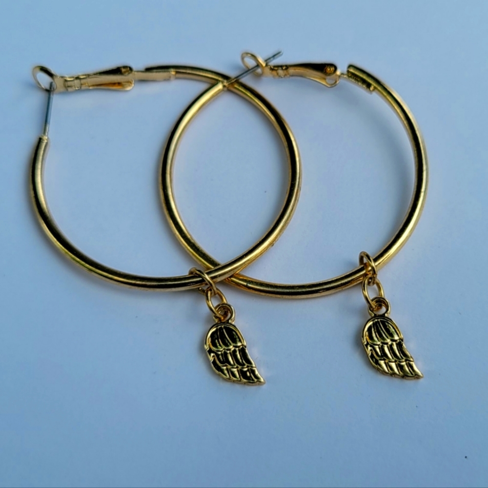 Gold hoops with wing charm